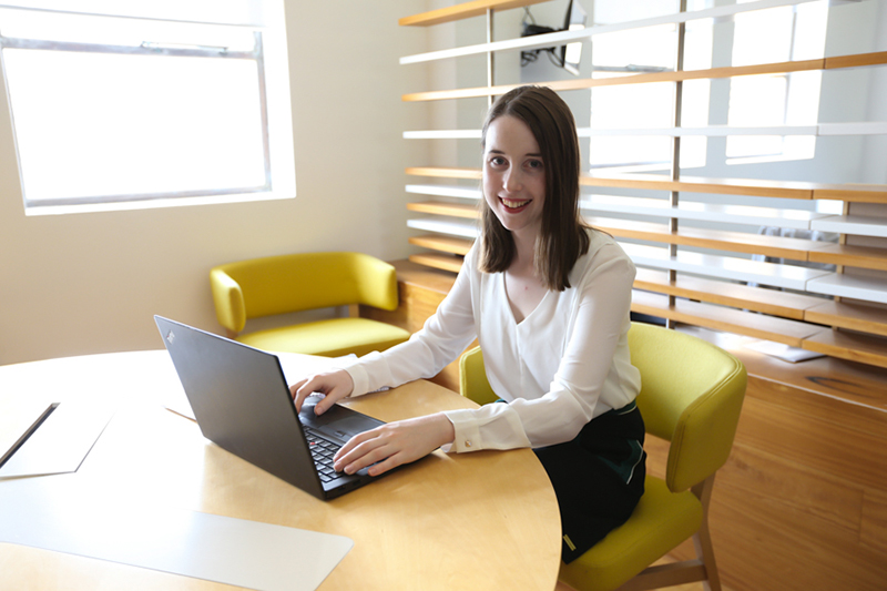 AT Kearney graduate at her desk