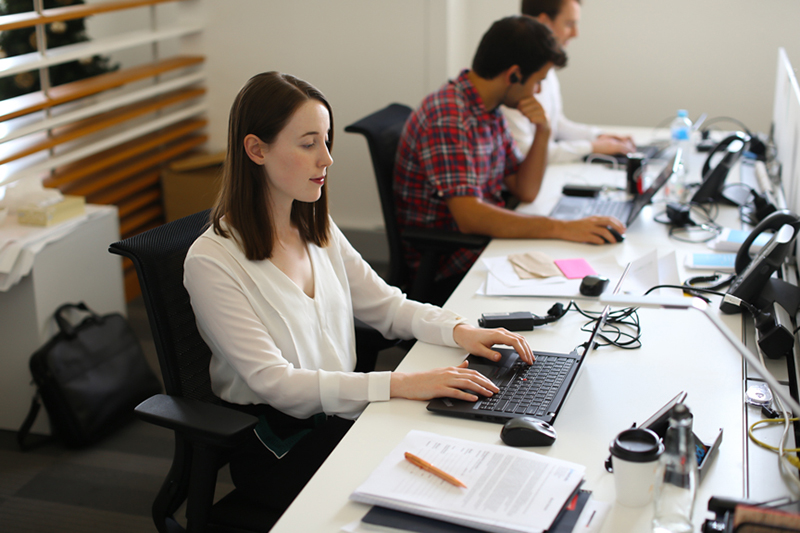 AT Kearney graduate working at her computer
