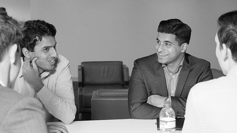 Jithin Xavier DXC Graduate talking with colleagues
