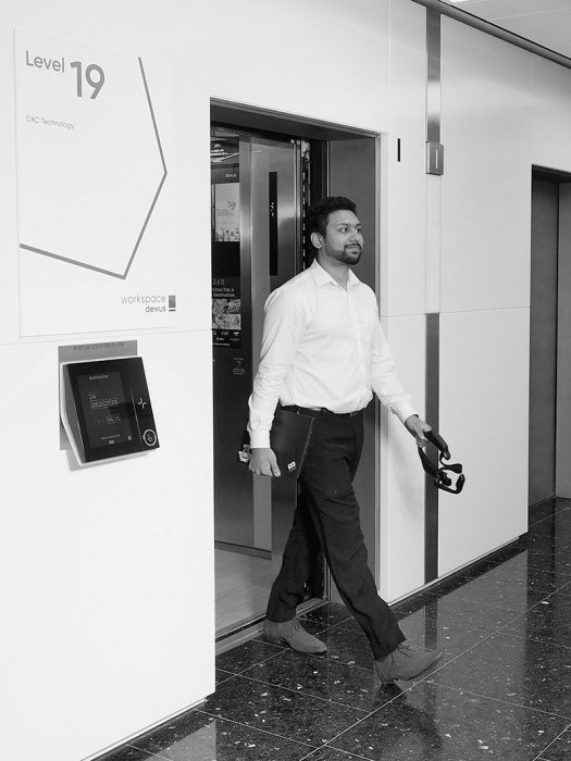 Niloy Chowdhury, DXC Graduate going out of a room