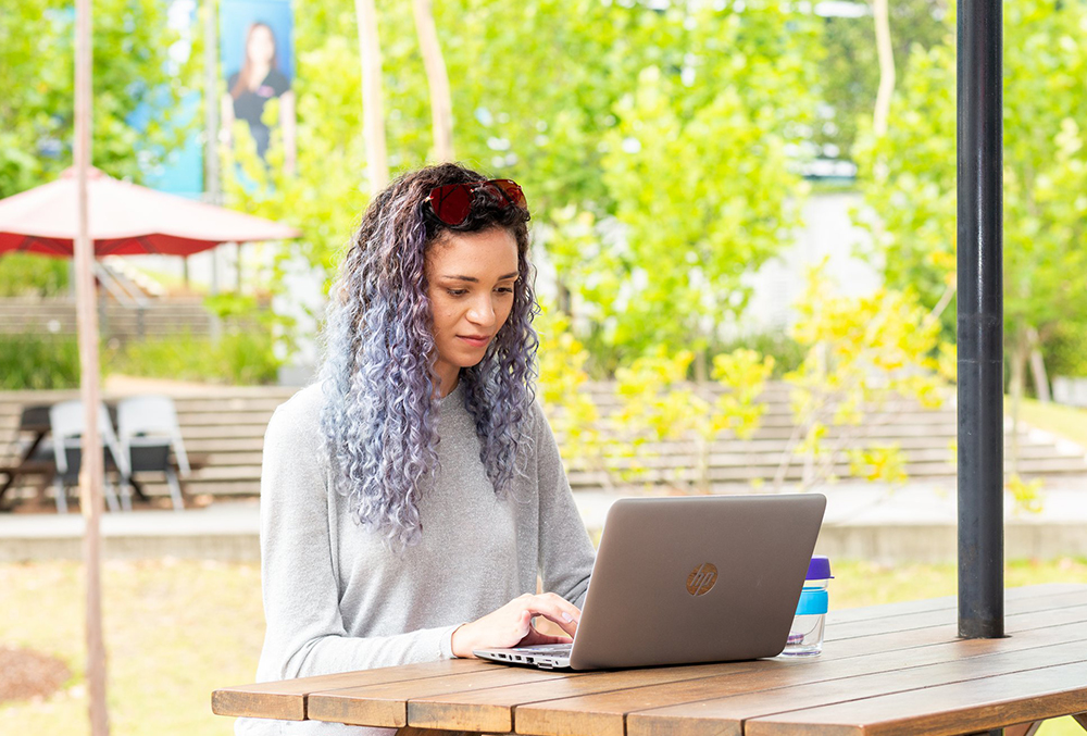Optus Graduate Isobel Fraser working outdoors