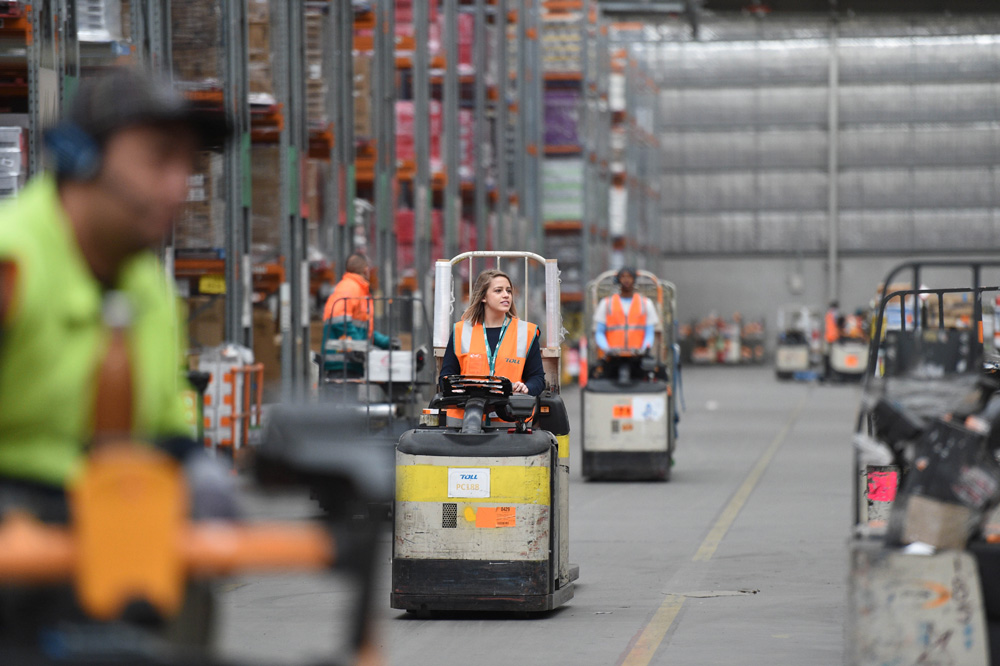 Toll Carly Morton learning how to use a small forklift