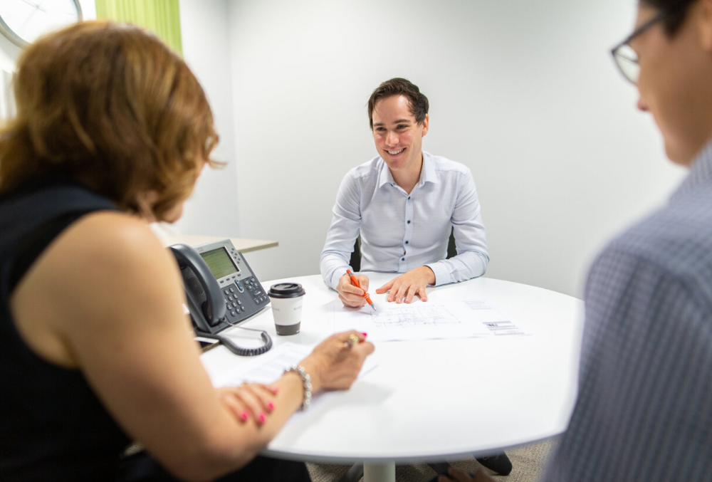 Josh having a meeting with his colleagues