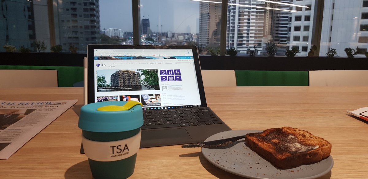 Kenny Lim checking his emails and having breakfast