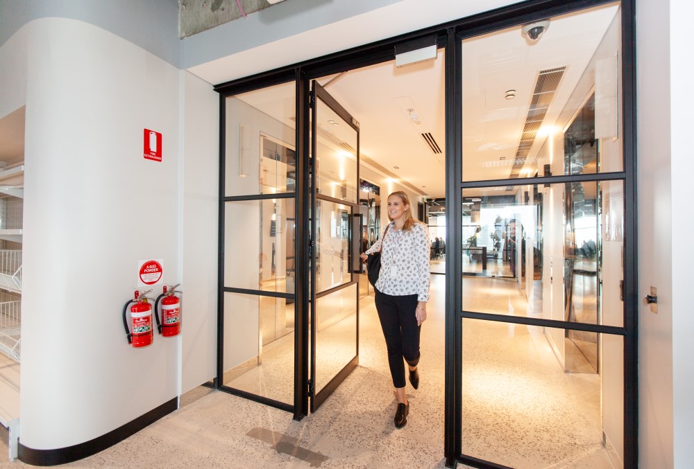 Kraft Heinz Graduate- Young executive walking through the door.