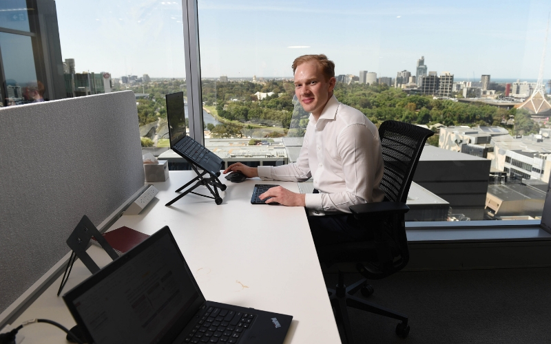 AT Kearney Graduate working at his desk