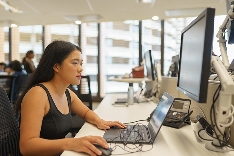 Inge Budihardjo in front of a laptop