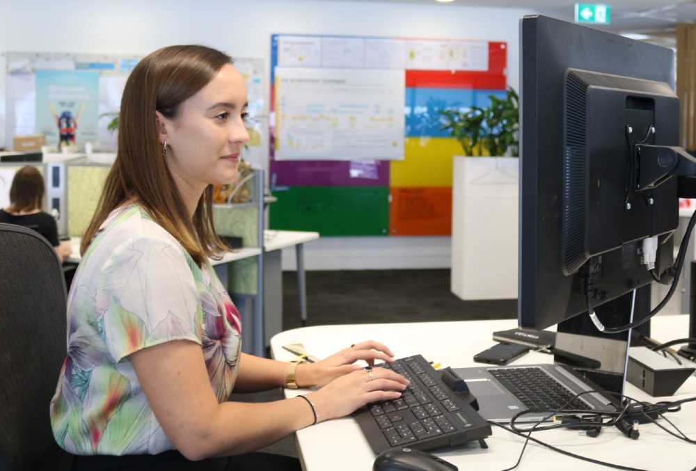 caitlin at her desk