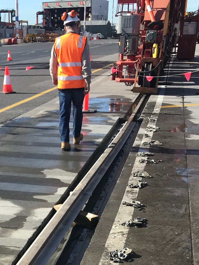 A professional checking on the crane rail