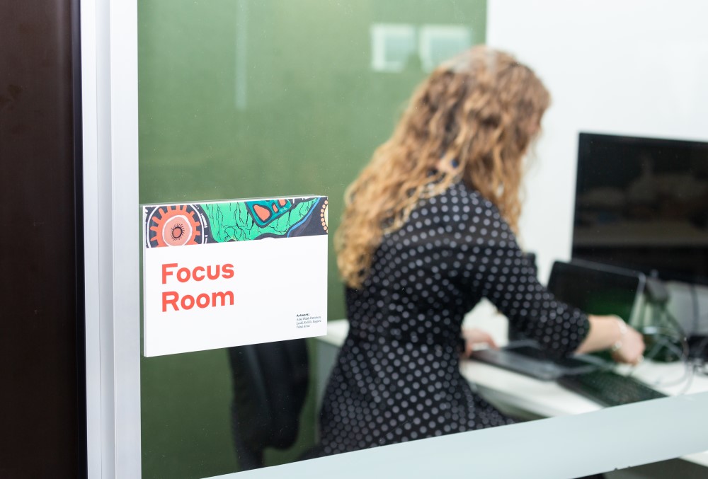WSP Graduate- A young female professional working inside a Focus Room.