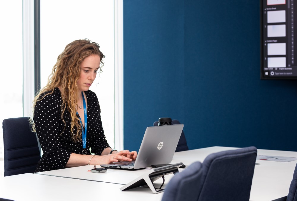 WSP Graduate- A young female professional preparing her presentation with the client.