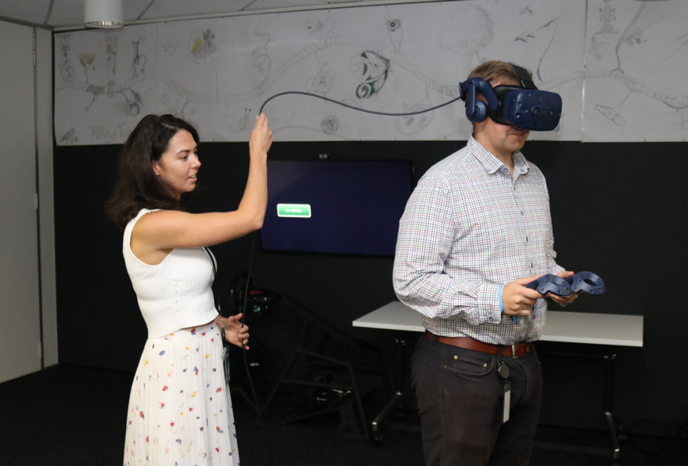 Beca Graduate- A female professional presenting VR with the client.