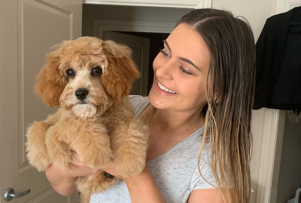 Coles Graduate - Female professional at home with her dog.