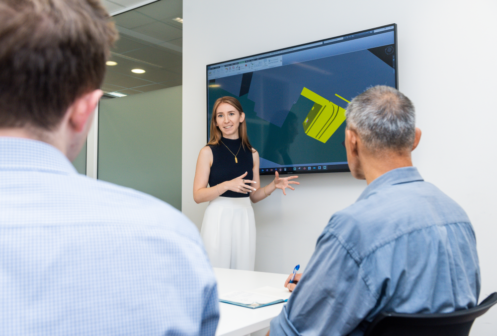 Downer Graduate- Young executive meeting with her colleagues.