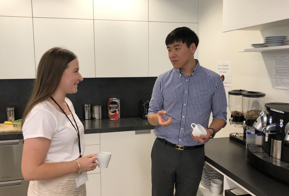 GSK Graduate- Two young professional getting coffee at the kitchen.