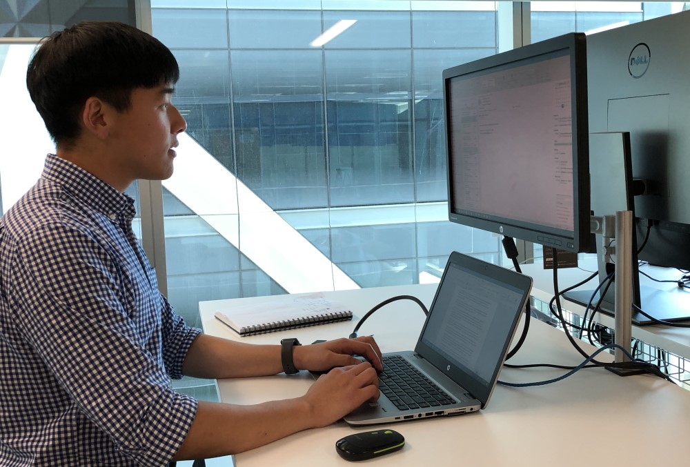 GSK Graduate- Young male professional working on his laptop.