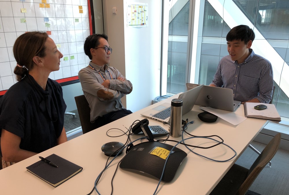 GSK Graduate- A young male professional having a meeting with colleagues.