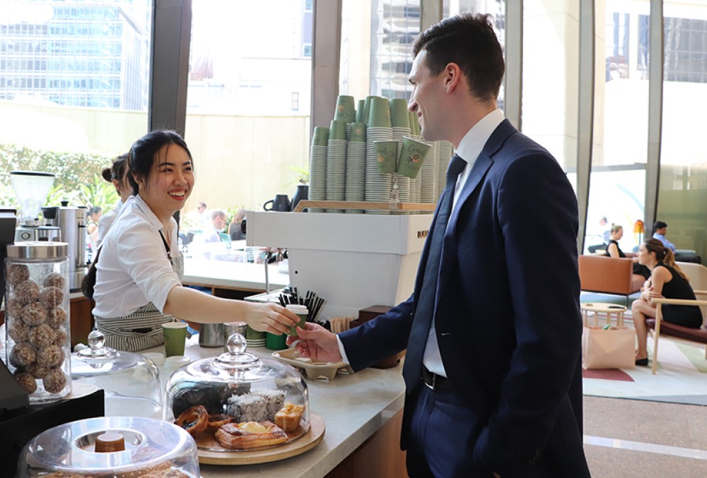 Sparke Helmore Lawyers Graduate - Young male lawyer grabbing some food for breakfast.