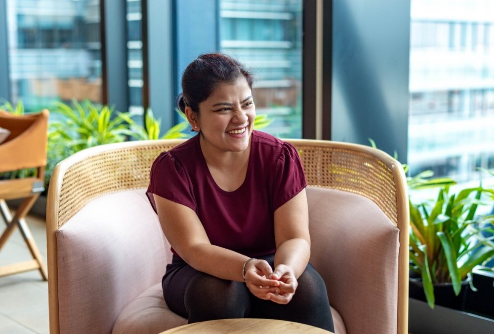The Data School Graduate - Female professional sitting on a lounge chair.